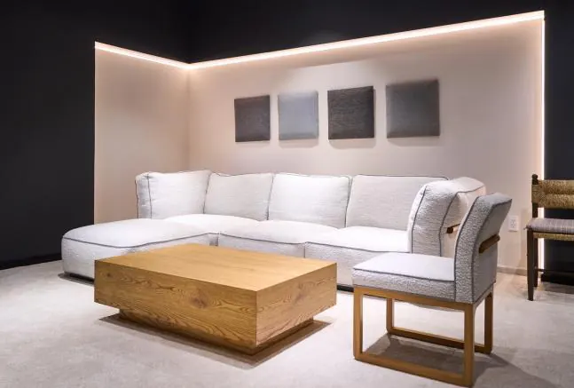 White sectional sofa and accent chair in a showroom setting